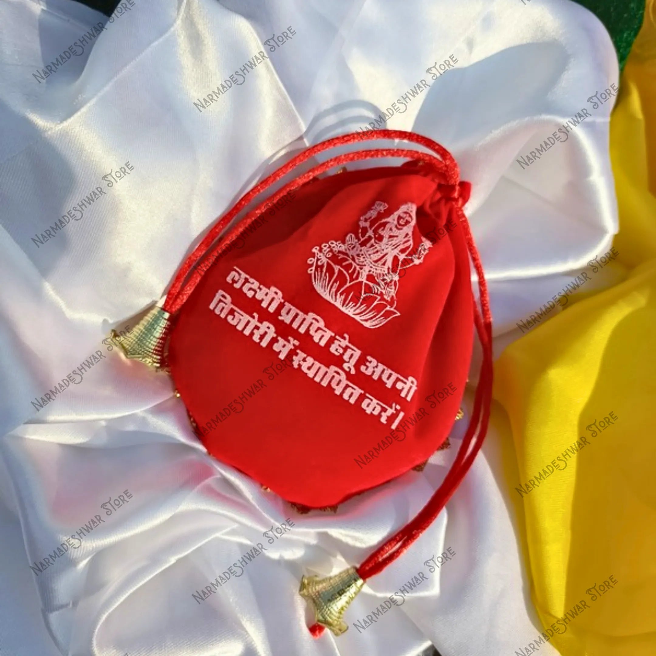 Divya Lakshmi Potli Red pouch with white text and gold accents on a white fabric background