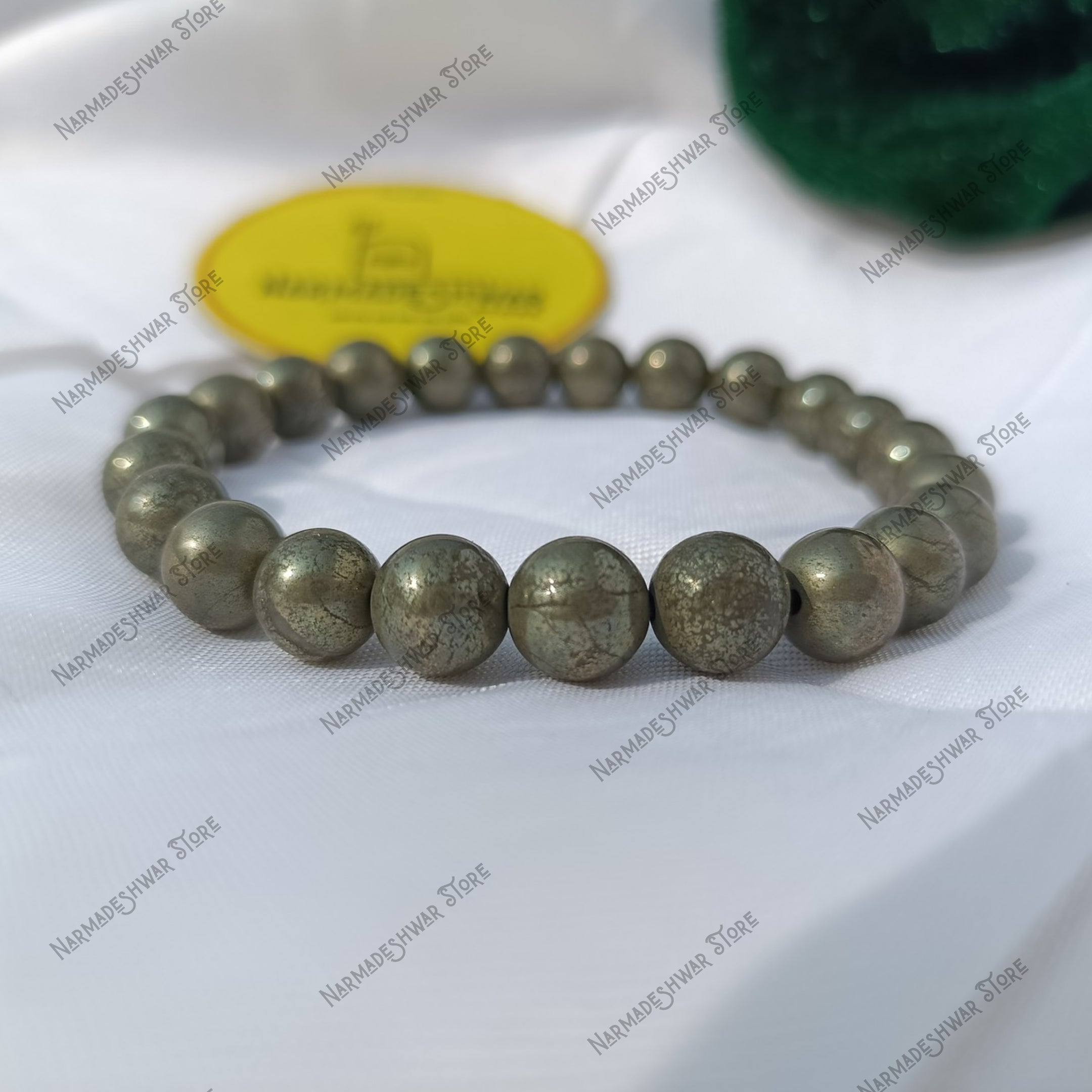 Golden natural Pyrite bracelet on red cloth – money attraction stone