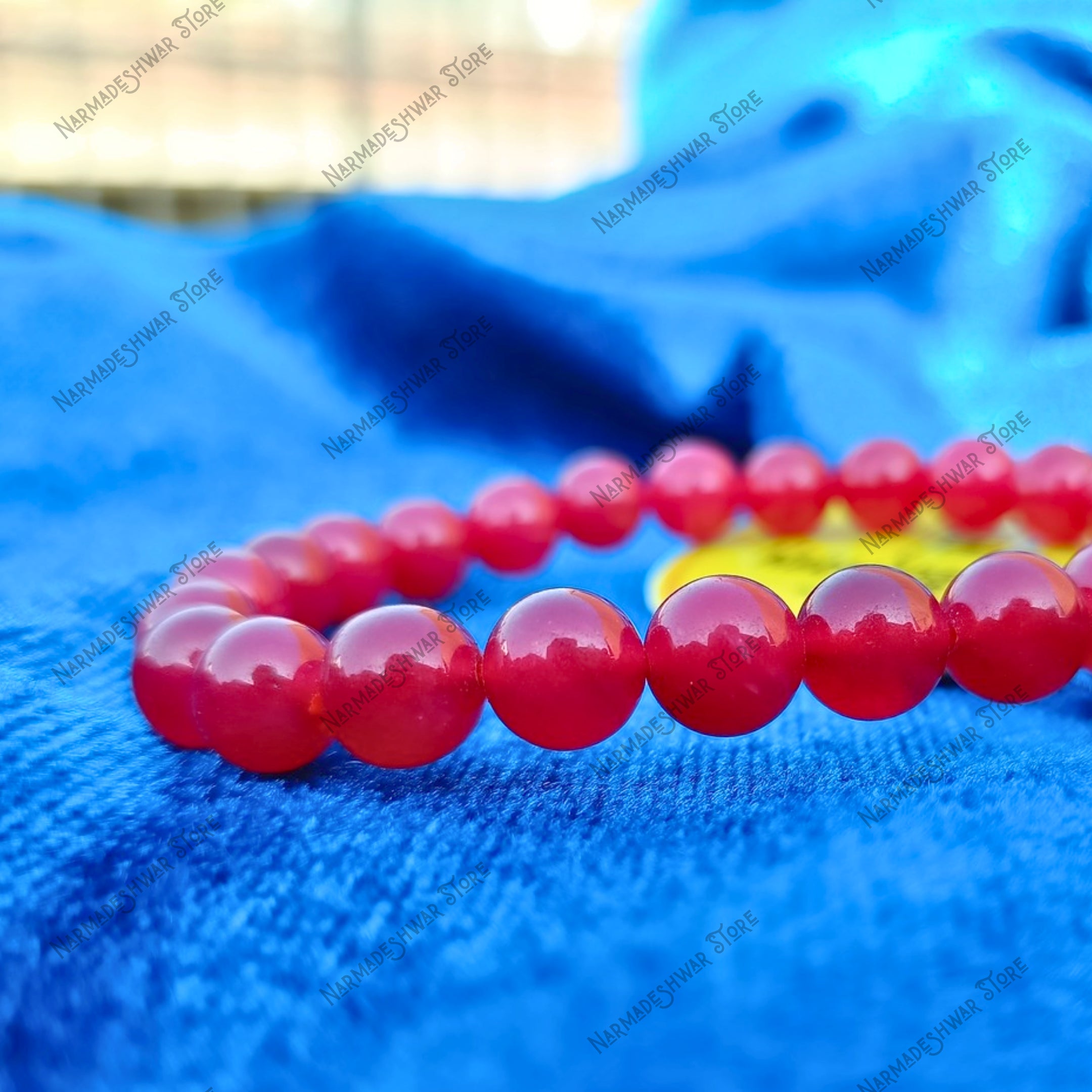 Red Agate Bracelet natural red crystal beads on blue background