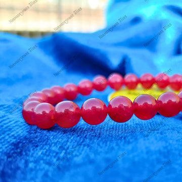 Red Agate Bracelet natural red crystal beads on blue background