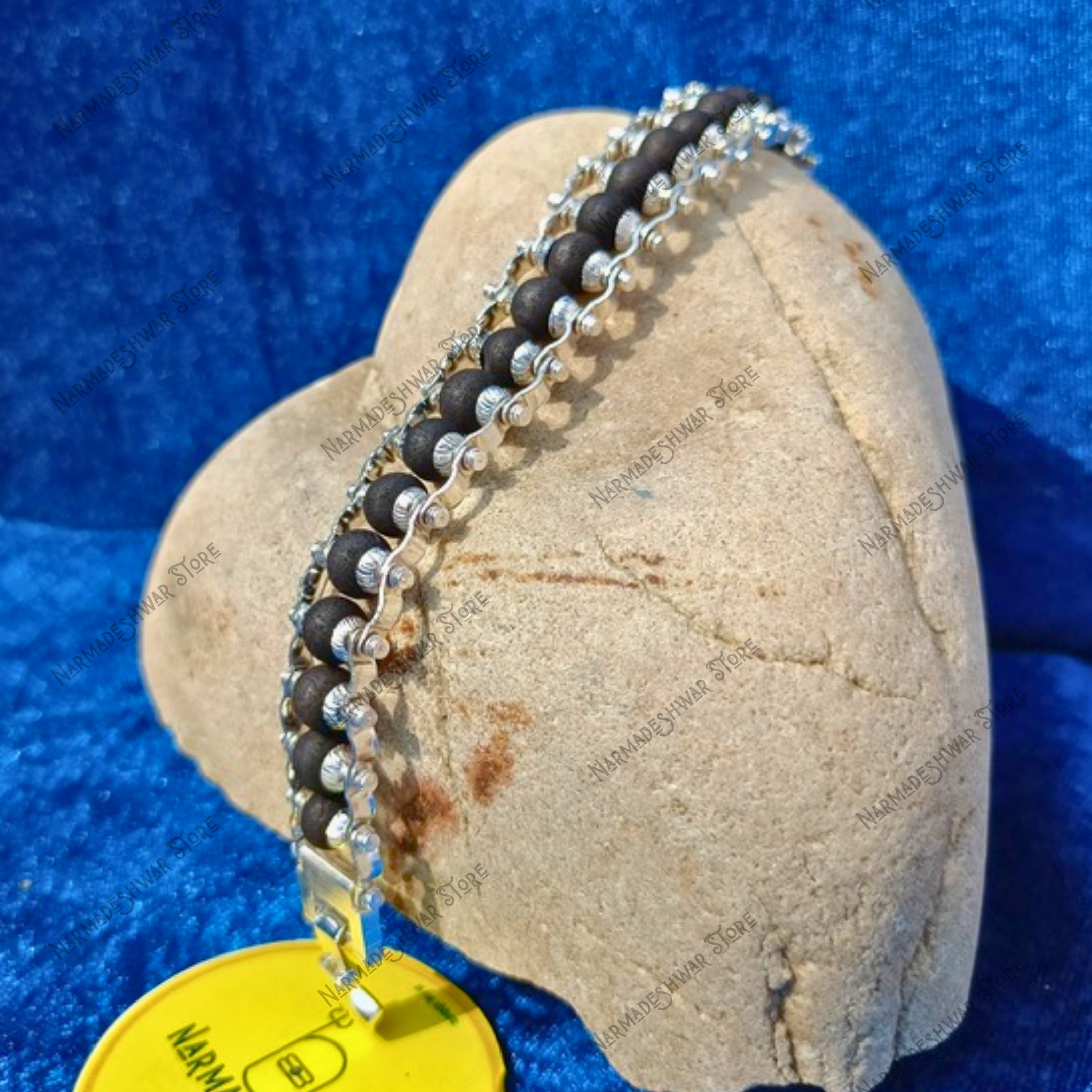 Silver Plated Karungali Bracelet on stone display