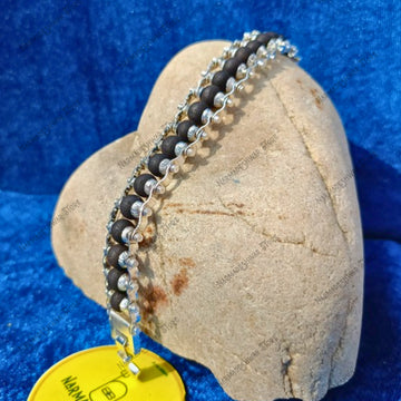 Silver Plated Karungali Bracelet on stone display