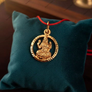 Lakshmi Locket on teal cushion with red thread — Vedic energized wealth pendant