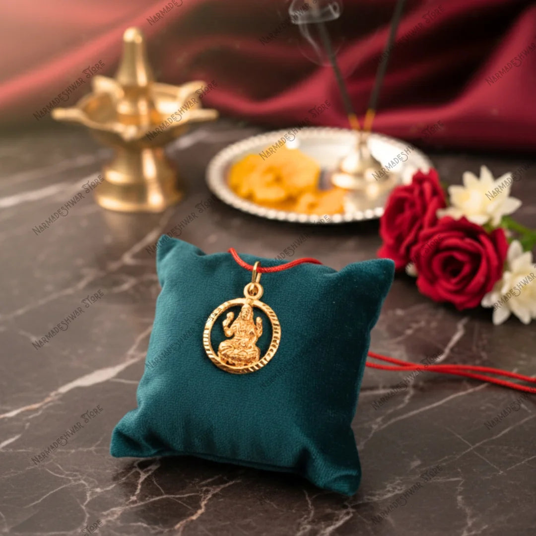 Vedic energized Lakshmi locket placed near diya and flower for puja